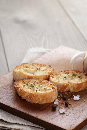 crostini with olive oil and garlic, on cutting boardの写真素材