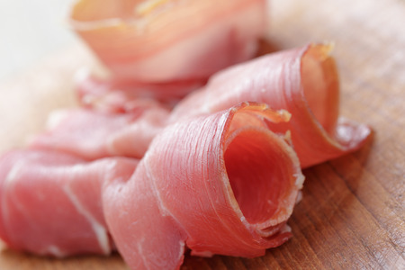 dried jamon slices on wood table, spanish traditional foodの写真素材