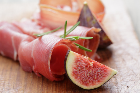 dried jamon slices with figs on wood table, spanish traditional foodの写真素材