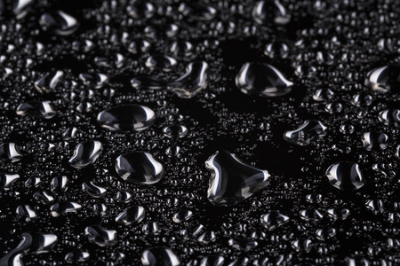 abstract water drops on polished stainless steel surface, close upの写真素材