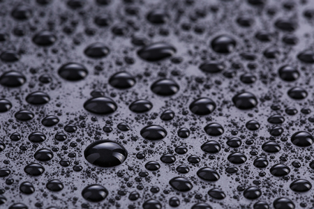 water drops on hydrophobic plastic surface, close upの写真素材