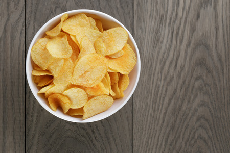 potato chips with paprika, on wood oak tableの写真素材