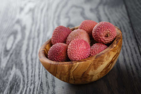 ripe cornel berrys in bowl, on old wood table