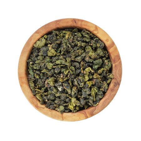 oolong green tea heap in bowl, isolated on white backgroundの写真素材