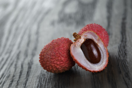 ripe lychee fruits, on old oak tableの写真素材