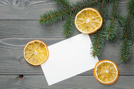 spruce twig with dried orange slices and greeting card, christmas backgroundの写真素材