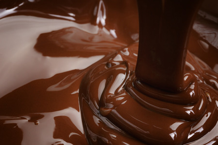 melted dark chocolate flow, candy or chocolate preparation backgroundの写真素材