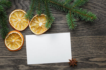 spruce twig with dried orange slices on oak table, christmas backgroundの写真素材