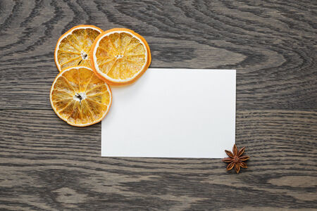 dried orange slices with paper card on oak table, christmas backgroundの写真素材