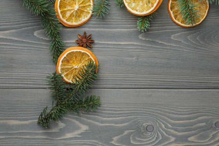 spruce twig with dried orange slices and anise, christmas backgroundの写真素材