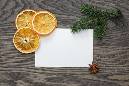 spruce twig with dried orange slices on oak table, christmas backgroundの写真素材