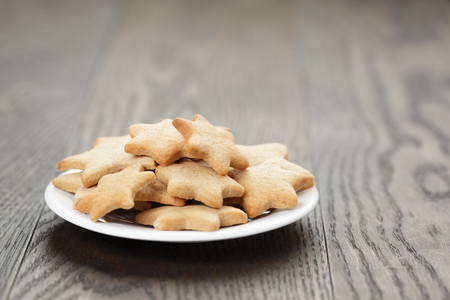 homemade star shape ginger cookies on wood table, rustic photoの写真素材