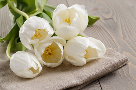 white tulips on rustic wood tableの写真素材