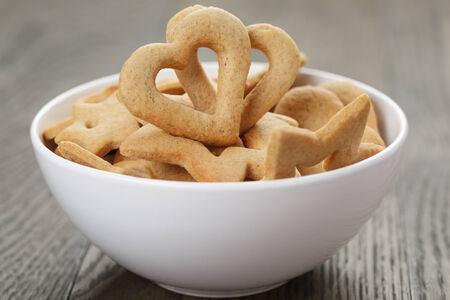 heart cookies for valentines day in white bowl on wood table, valentines day themeの写真素材