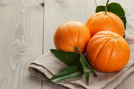 ripe spanish oranges on wood table, rustic photoの写真素材
