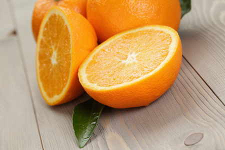 ripe spanish oranges on wood table, rustic photoの写真素材