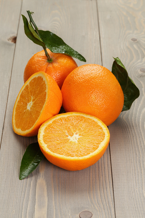 ripe spanish oranges on wood table, rustic photoの写真素材