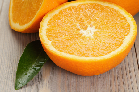 ripe spanish oranges on wood table, rustic photoの写真素材