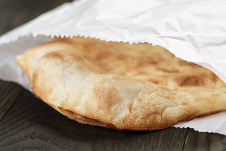 close up of frshly baked flat bread in paper bagの写真素材
