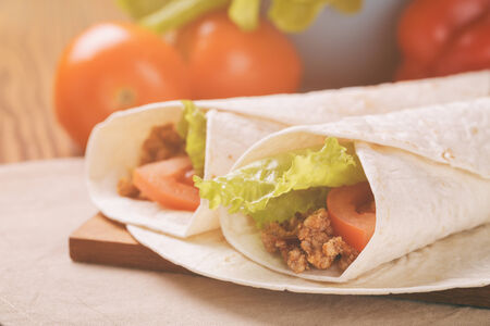 Fresh tortilla wraps with meat and vegetables, vintage tonedの写真素材