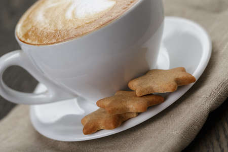 cup of cappuccino with home cookies, on old tableの写真素材