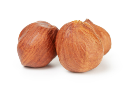 three hazelnut kernels isolated on white backgroundの写真素材
