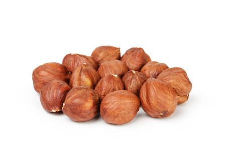 Heap of peeled hazelnuts isolated on whiteの写真素材