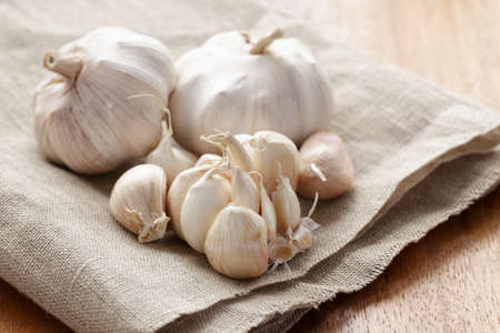 fresh organic garlic on sack clothの写真素材
