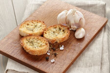 crostini with olive oil and garlic, on cutting boardの写真素材