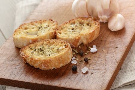 crostini with olive oil and garlic, on cutting boardの写真素材