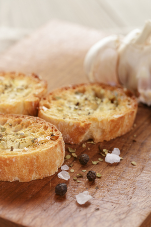 crostini with olive oil and garlic, on cutting boardの写真素材