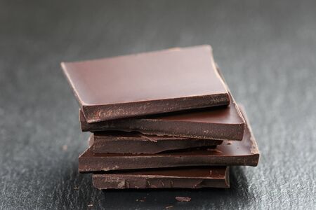 stack of chocolate thin pieces, on slate boardの写真素材
