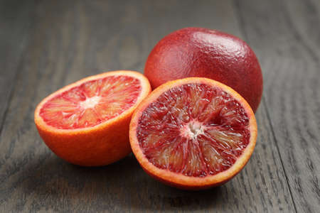 red sicilian oranges sliced on wooden tableの写真素材