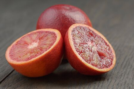 red sicilian oranges sliced on wooden tableの写真素材