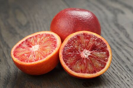 red sicilian oranges sliced on wooden tableの写真素材