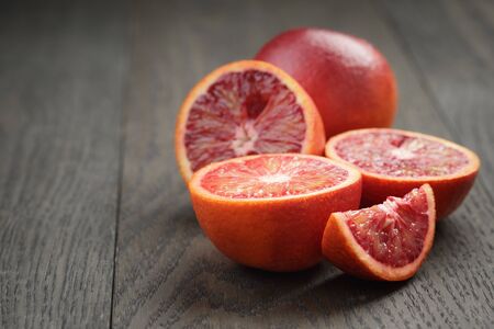 red sicilian oranges sliced on wooden tableの写真素材