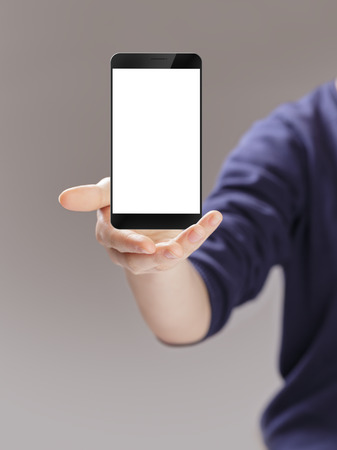digitally created generic smartphone with blank screen presented by female handの写真素材