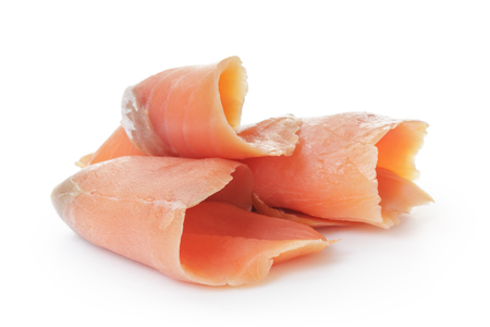 rolled sliced salmon isolated on whiteの写真素材