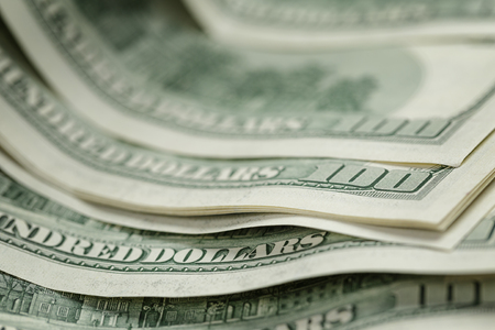 hundred dollar bills on wood tableの写真素材