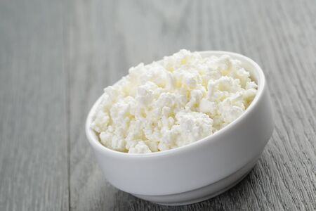 cottage cheese in white bowl on old tableの写真素材