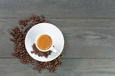 feshly made espresso with coffee beans on wooden tableの写真素材