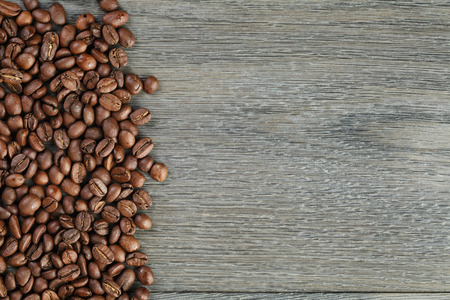 freshly roasted coffee beans on wooden tableの写真素材