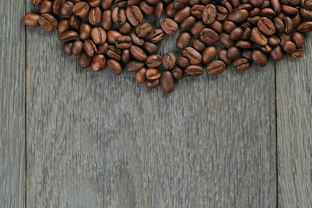 freshly roasted coffee beans on wooden tableの写真素材