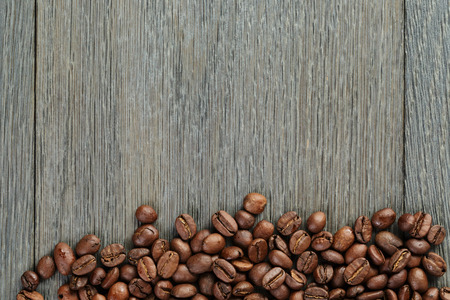 freshly roasted coffee beans on wooden tableの写真素材