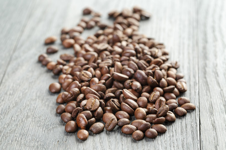 freshly roasted coffee beans on wooden tableの写真素材
