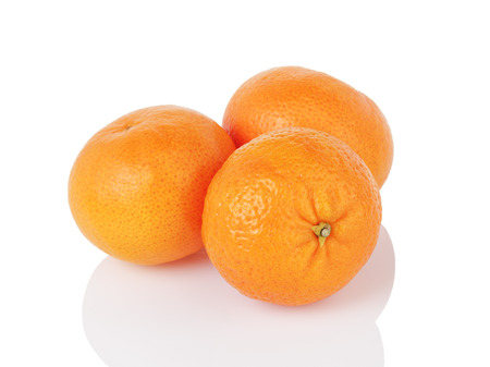 three ripe tangerines isolated on whiteの写真素材