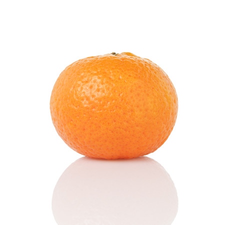 one ripe tangerines isolated on whiteの写真素材