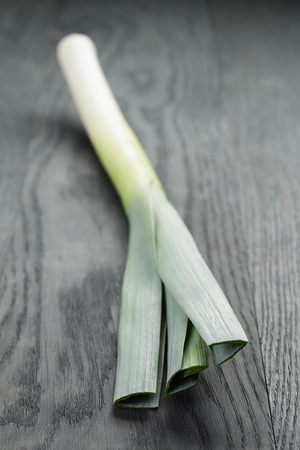 fresh organic leek on vintage oak tableの写真素材