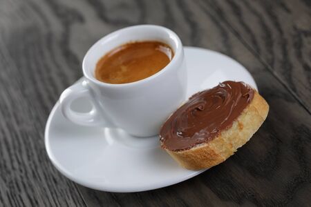 cup of coffee with baguette and chocolate spreadの写真素材