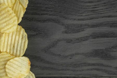 rippled organic chips border on wooden tableの写真素材